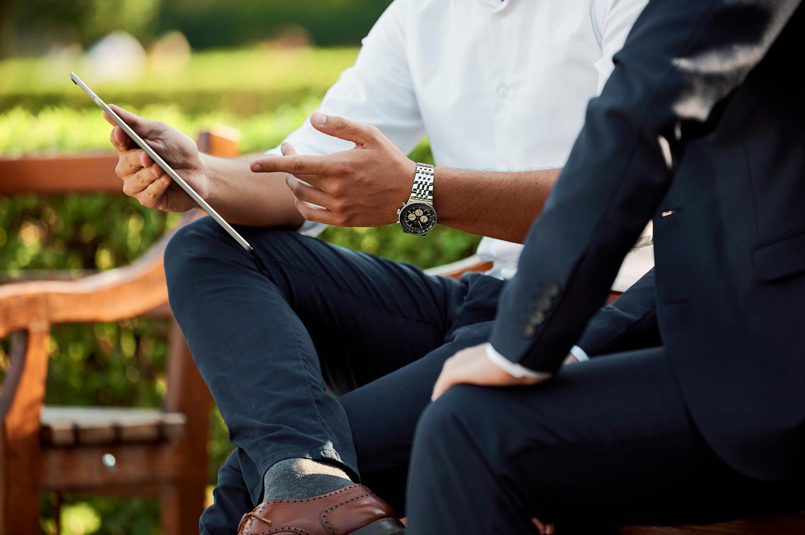 Consultant presenting a project plan to a client on a tablet