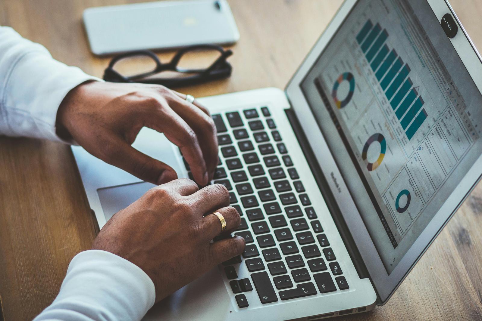 Finance and inventory reports reviewed on a laptop